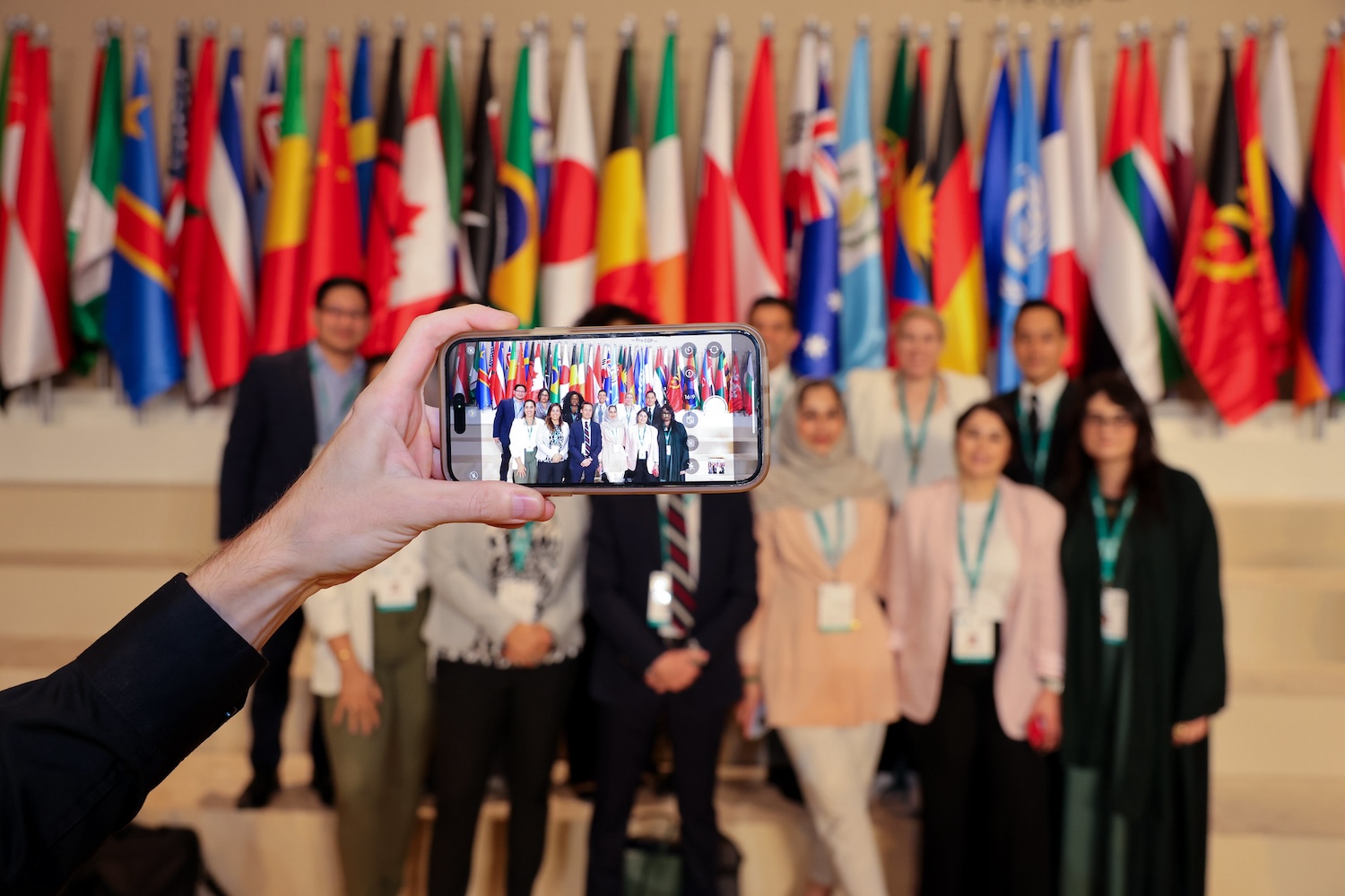 delegates pose for a photo at the pre-COP events ahead of COP28 in dubai